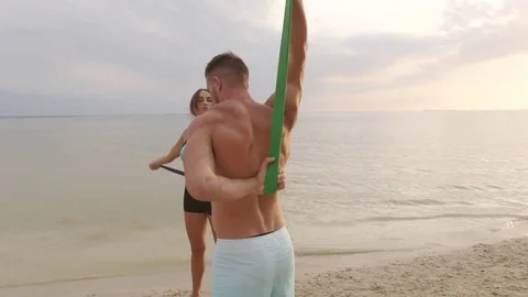 Couple practicing acroyoga at sunrise Stock Footage 77154547