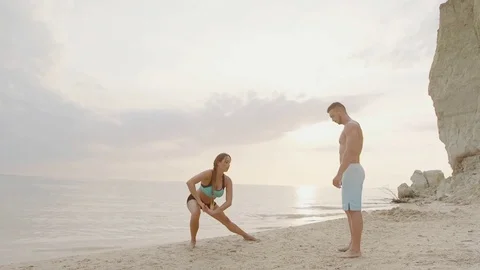 Couple practicing acroyoga at sunrise Stock Footage 77154606
