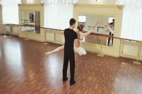 Couple practicing ballet dancing in front of mirrors, slow-mo Stock Footage 40287685