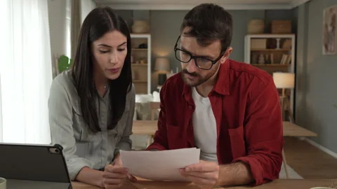 Couple prepare documents for work have coffee and breakfast at home Stock Footage 277300314