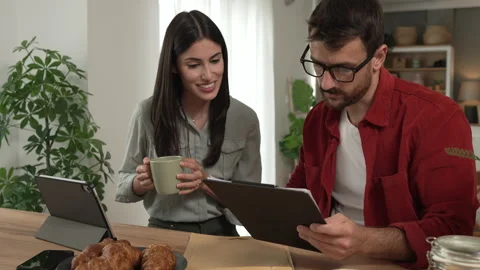 Couple prepare documents for work have coffee and breakfast at home Stock Footage 277300563