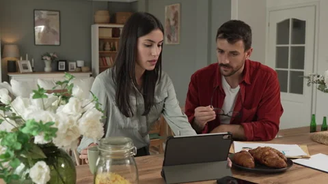 Couple prepare documents for work have coffee and breakfast at home Stock Footage 277301404