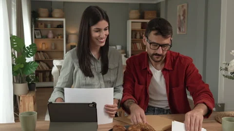Couple prepare documents for work have coffee and breakfast at home Stock Footage 277301563
