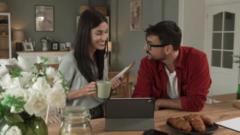 Couple prepare documents for work have coffee and breakfast at home Stock Footage 277301568