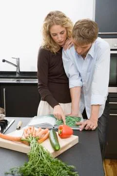 A couple preparing to cook in the kitchen Stock Photos
