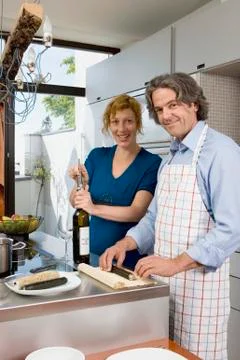 A couple preparing dinner in the kitchen Stock Photos