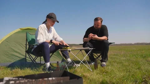 Couple preparing food together during a camping picnic in nature Stock-Footage 344603753