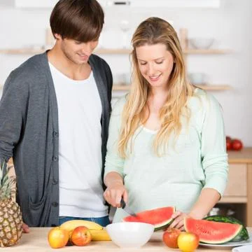 Couple preparing fruit salad Stock Photos