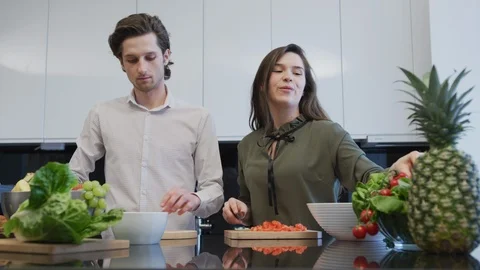 Couple preparing a salad Stock Footage 99941679