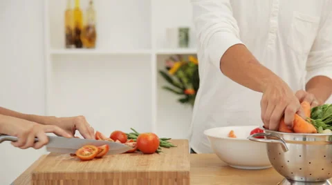 Couple Preparing a Salad in Kitchen Stock Footage 912351