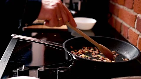 Couple preparing scrambled eggs in the kitchen at home, focus on hands Stock Footage 93108565