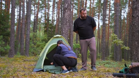 Couple preparing a tent for camping in the forest Stock Footage 327130120