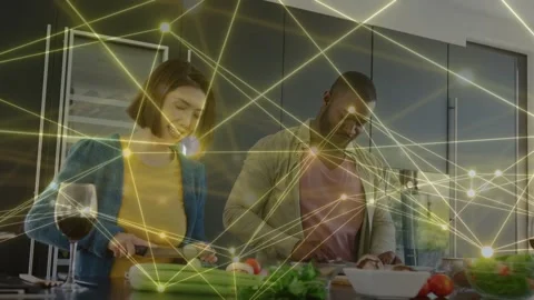 Couple prepping dinner at kitchen island, chopping veg while node overlay 스톡 동영상 333925389