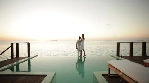 Couple on private pool watching sunset Stock Footage 1018103