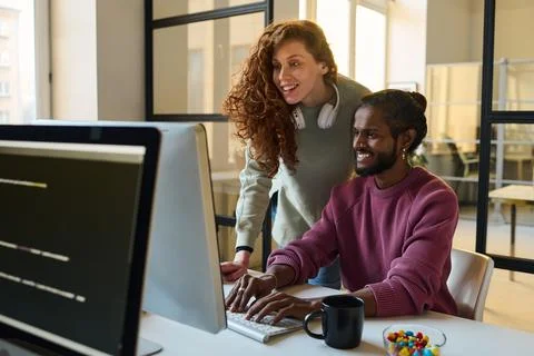 Couple of programmers working in team Stock Photos