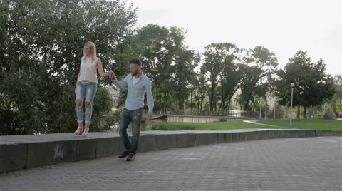 A couple promenading in the park Stock Footage 66187392