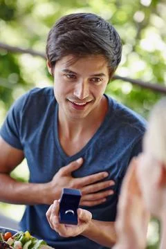 Couple, proposal and man with ring on holiday for commitment, future and Stock Photos