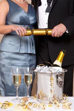 Couple pulling a christmas cracker Stock Photos