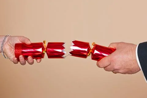 Couple pulling a christmas cracker Stock Photos
