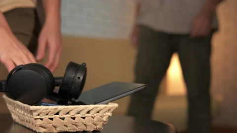 Couple putting away devices for a digital detox at home Video stock 344151721