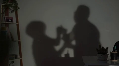 A couple quarreling, the shadow of fighting on the wall, domestic violence Stock Footage