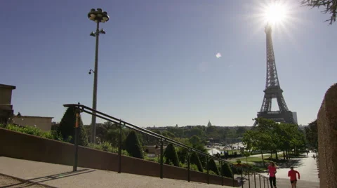 Couple race up steps by the Eiffel Tower, while jogging in Paris. Stock Footage 63019545