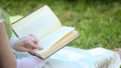 Couple reading a book outdoors Stock Footage 76184825