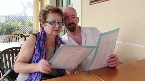Couple reading choosing from menu Stock Footage 12520832