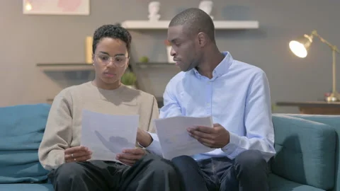Couple Reading Documents Together on Sofa Video stock 170733156