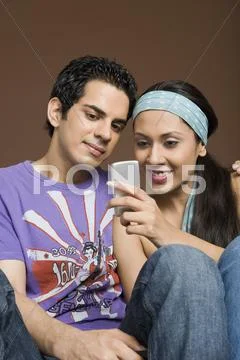 Couple reading a message on a mobile phone Stock Photos