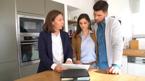 Couple with real-estate agent visiting house for sale Stock-Footage 72010883