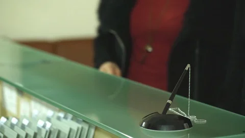 Couple at the reception of a hotel checking in Stock Footage 74330715