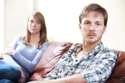 Couple With Relationship Difficulties Sitting On Sofa Stock Photos