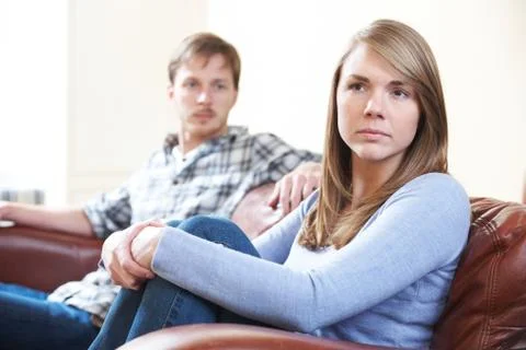 Couple With Relationship Difficulties Sitting On Sofa Stock Photos