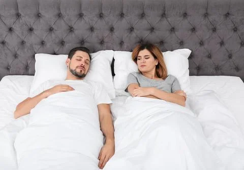Couple with relationship problems in bed at home Stock Photos