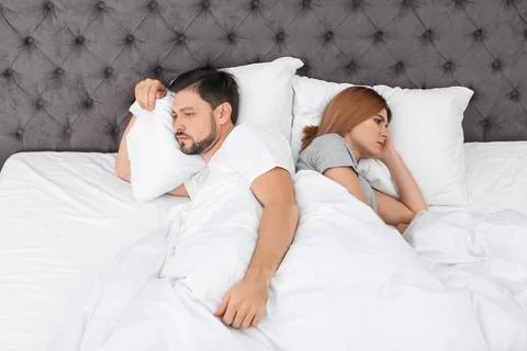 Couple with relationship problems in bed at home Stock Photos