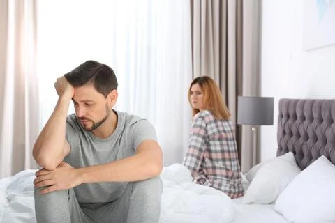 Couple with relationship problems ignoring each other in bedroom Stock Photos