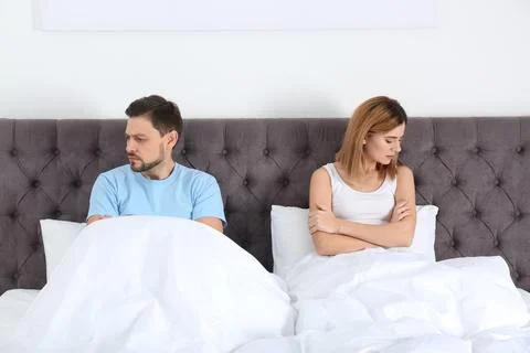 Couple with relationship problems ignoring each other in bedroom Stock Photos