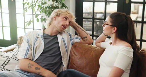 Couple, relax and talk on sofa at house for first date, explain interests and Stock Footage 321861123