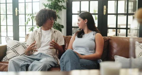 Couple, relax and talking on couch in home for first date, explain interests and Stock Footage 321862378