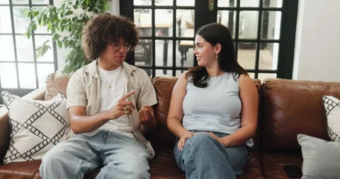 Couple, relax and talking on sofa at house for first date, explain interests and Stock Footage 321841758