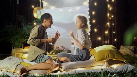 Couple relax on decorated backyard Stock Footage 260335391