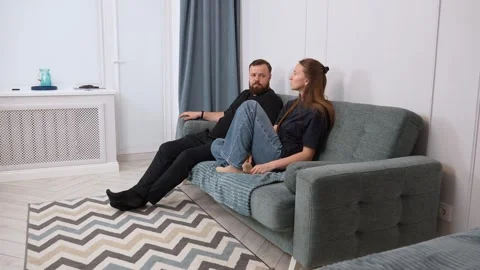 Couple relaxing and talking on sofa in living room Stock Footage 317441632