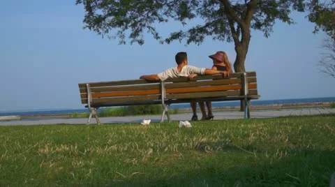 Couple Relaxing On Beach Bench Stock Footage 11520405