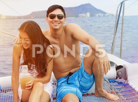 Couple Relaxing On Boat In Ocean