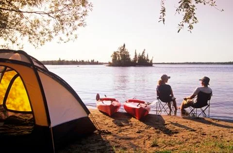Couple relaxing at Otter Falls campground Whiteshell Provincial Park, Manitoba, Stock Photos