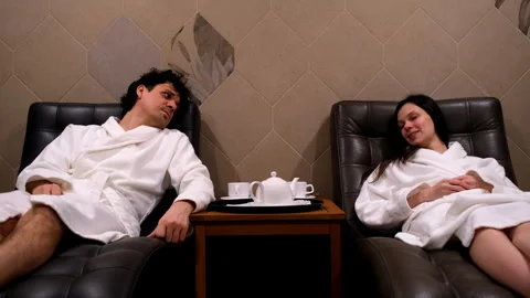Couple relaxing resting lying in soft comfort armchairs in modern sauna. Stock-Footage 272906530