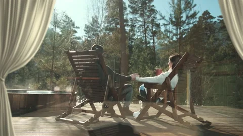 Couple relaxing in rocking chairs on woo... | Stock Video | Pond5