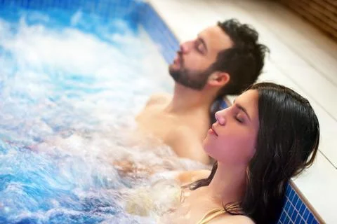 Couple relaxing in spa jacuzzi. Foto stock