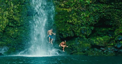 Couple Relaxing Under Waterfall Stock Footage 64928975